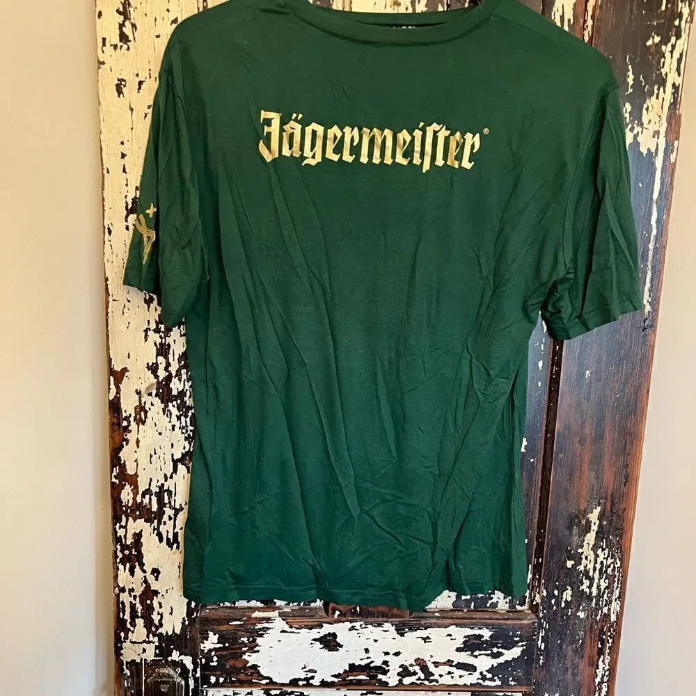 Women’s distressed cut out super soft Jäegermeister dri-fit T-shirt. Size Med.